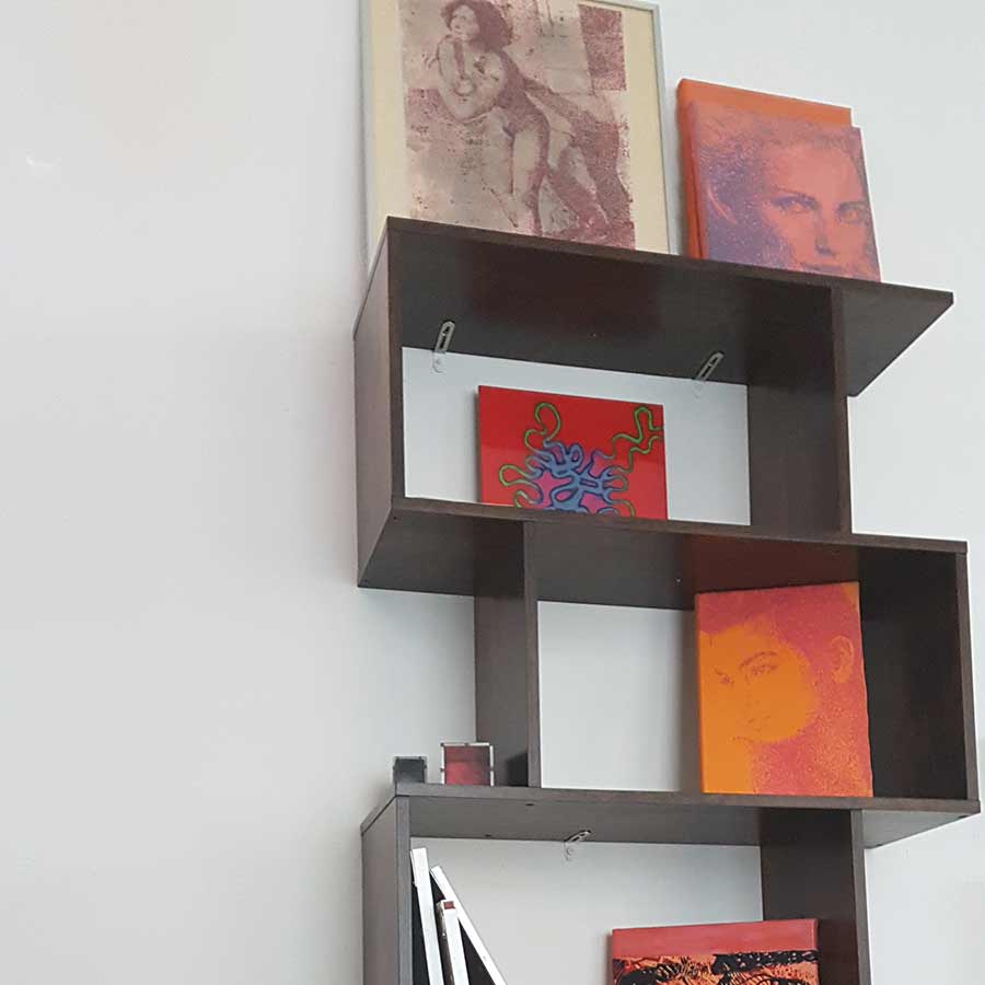 small paintings on a shelf