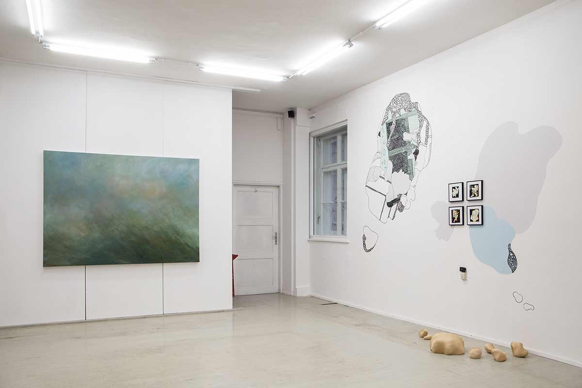 abstract painting and wall drawings with sculptures on the ground