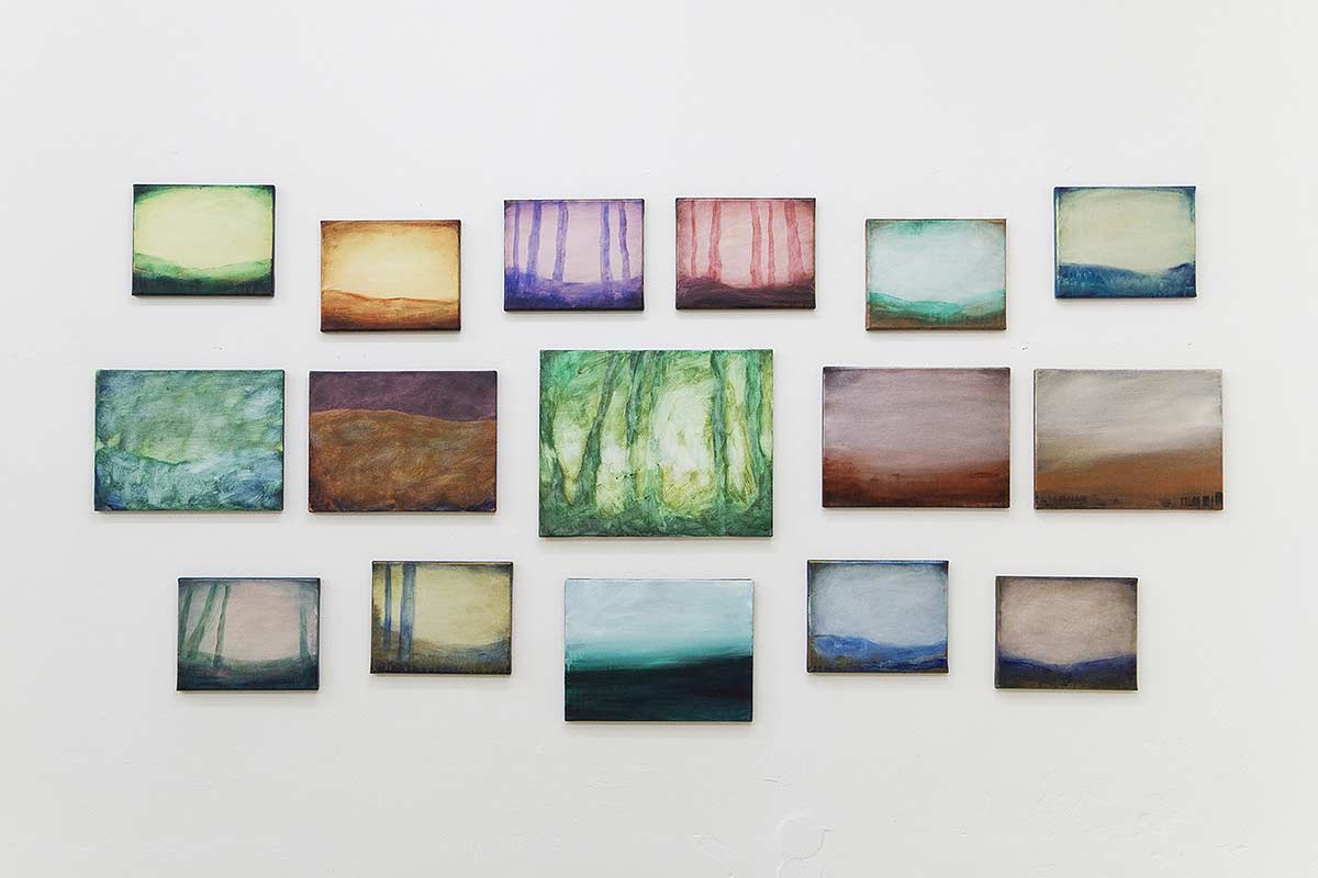 small canvases of abstract paintings showing forests and places